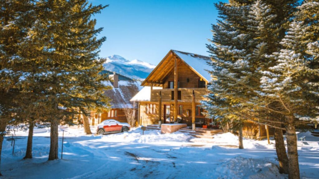 luxury log cabin set in the snowy trees in estes park co
