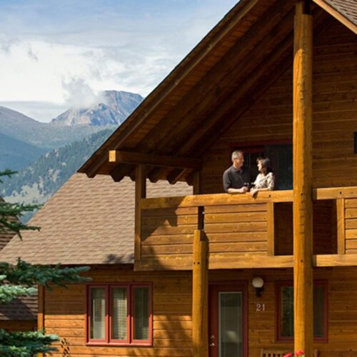 could standing on balcony of their Colorado cabin at Rams Horn Village Resort